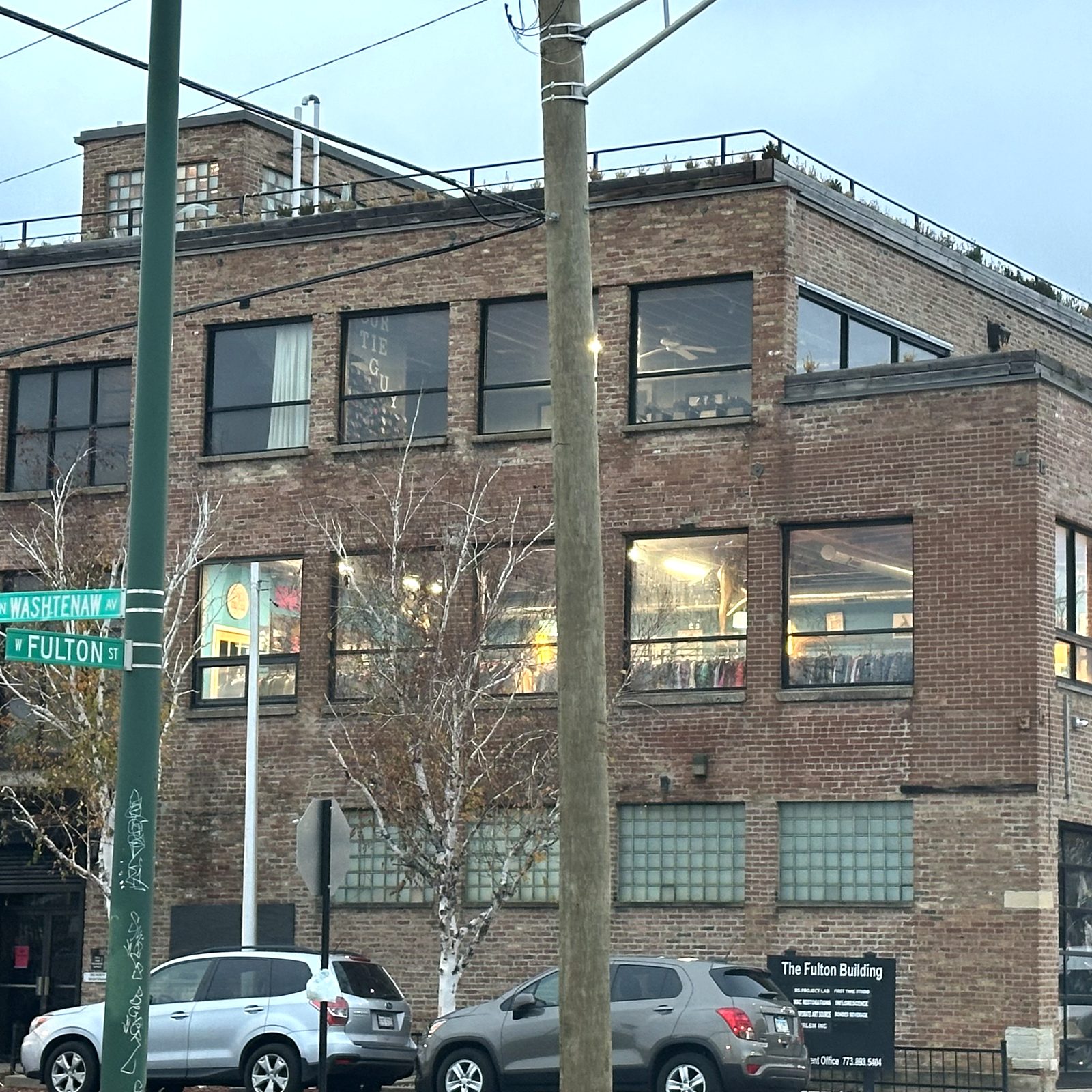 The Washtenaw & Fulton corner of the building, with the street signs and the 'The Fulton Building' wall sign.